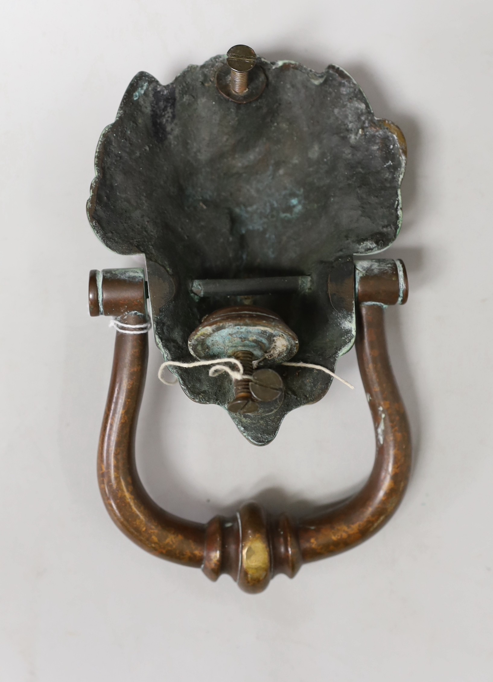 A large bronze lion mask door knocker. 20cm tall overall